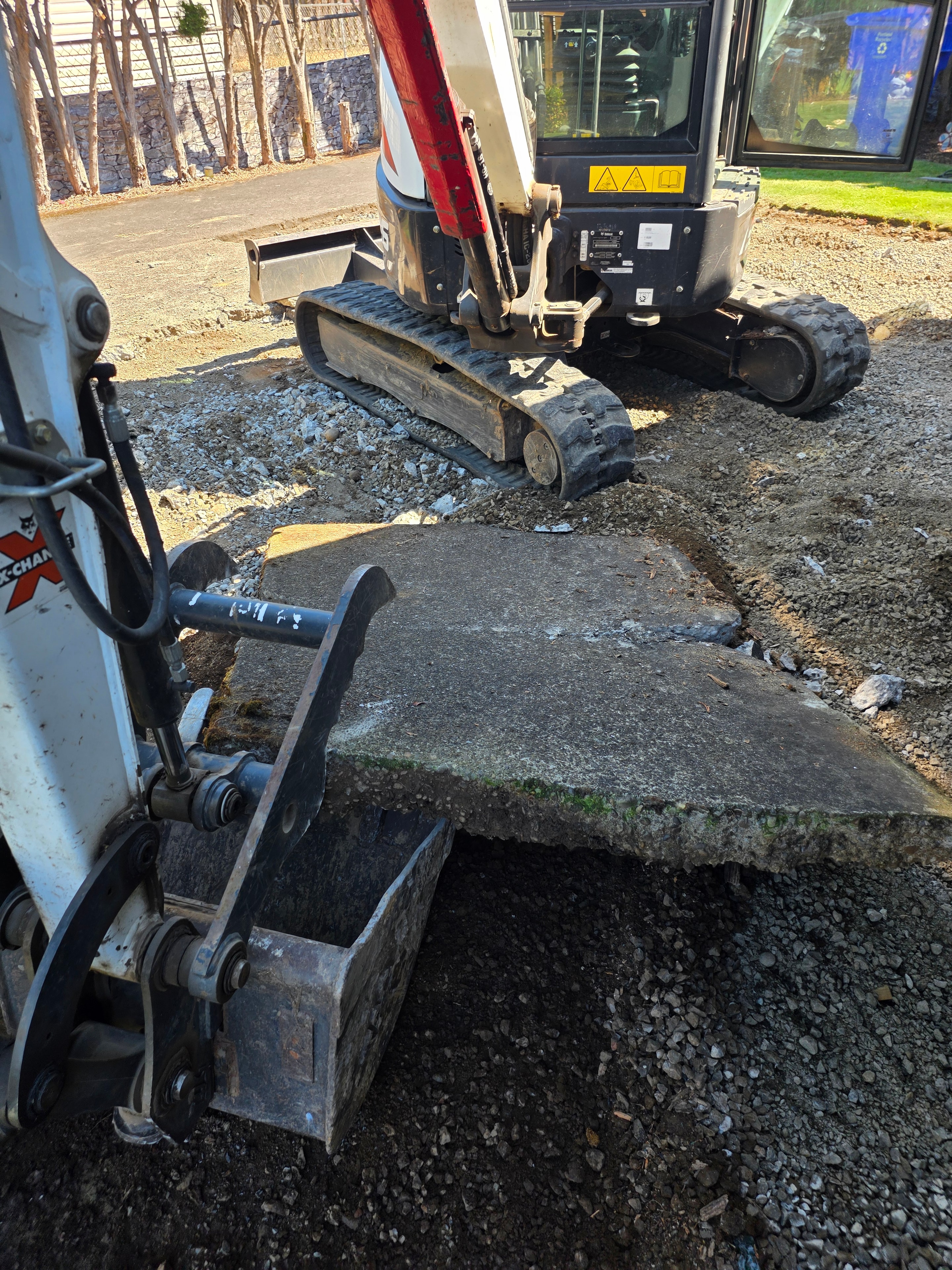 Failed concrete driveway showing settlement and cracking