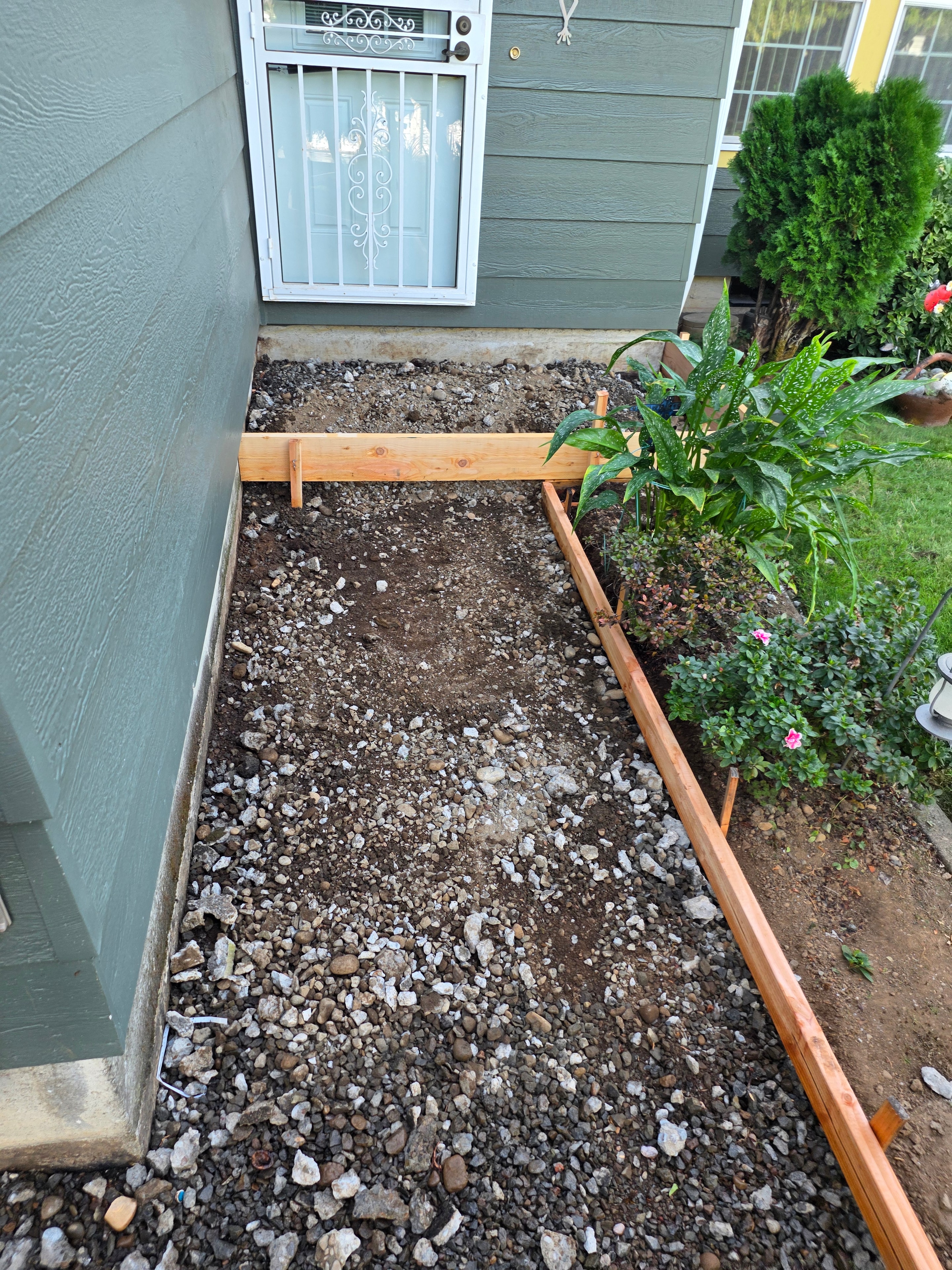 Forming and grading driveway base before concrete pour
