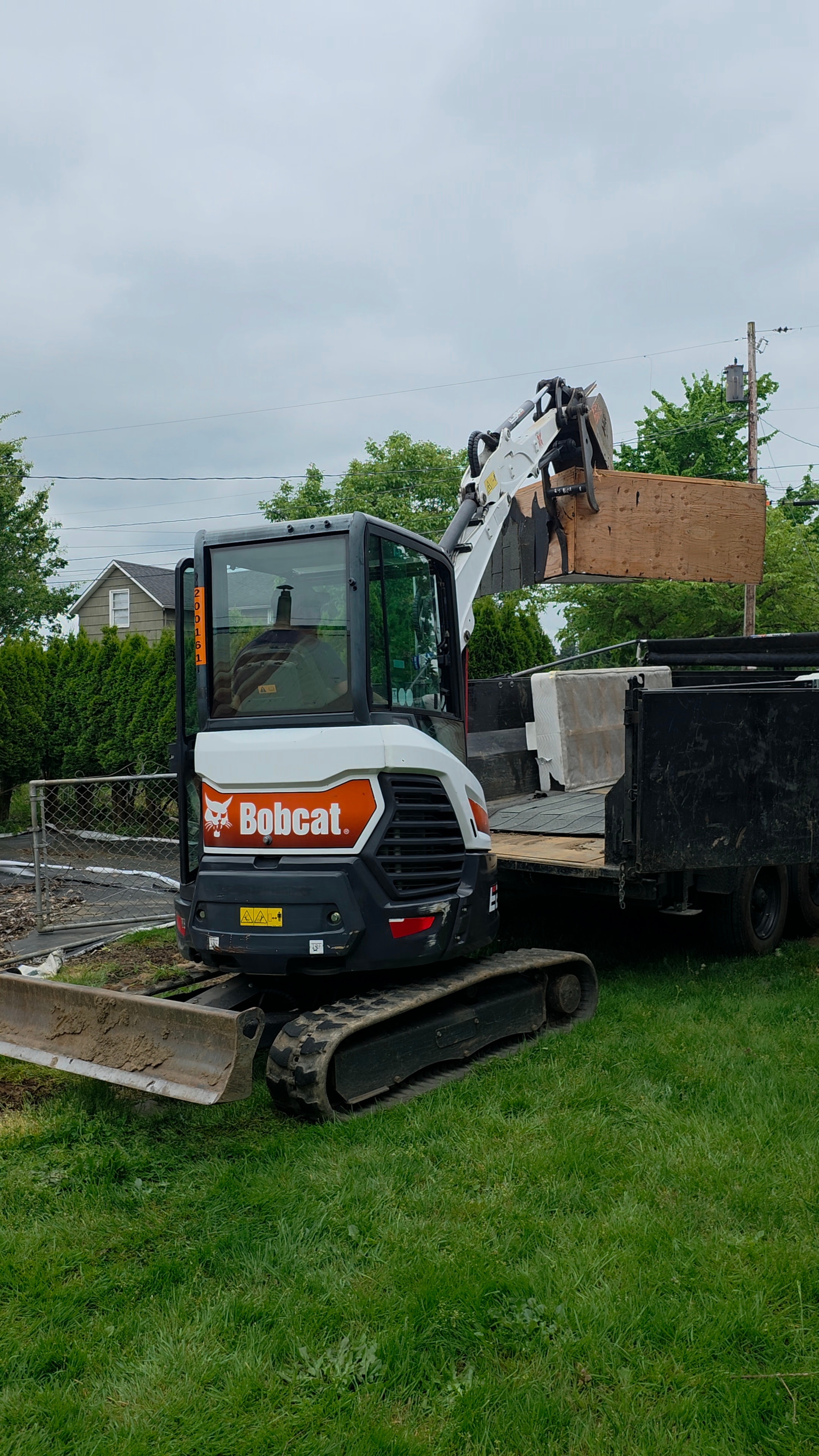 Bobcat hauling demolition debris during building removal
