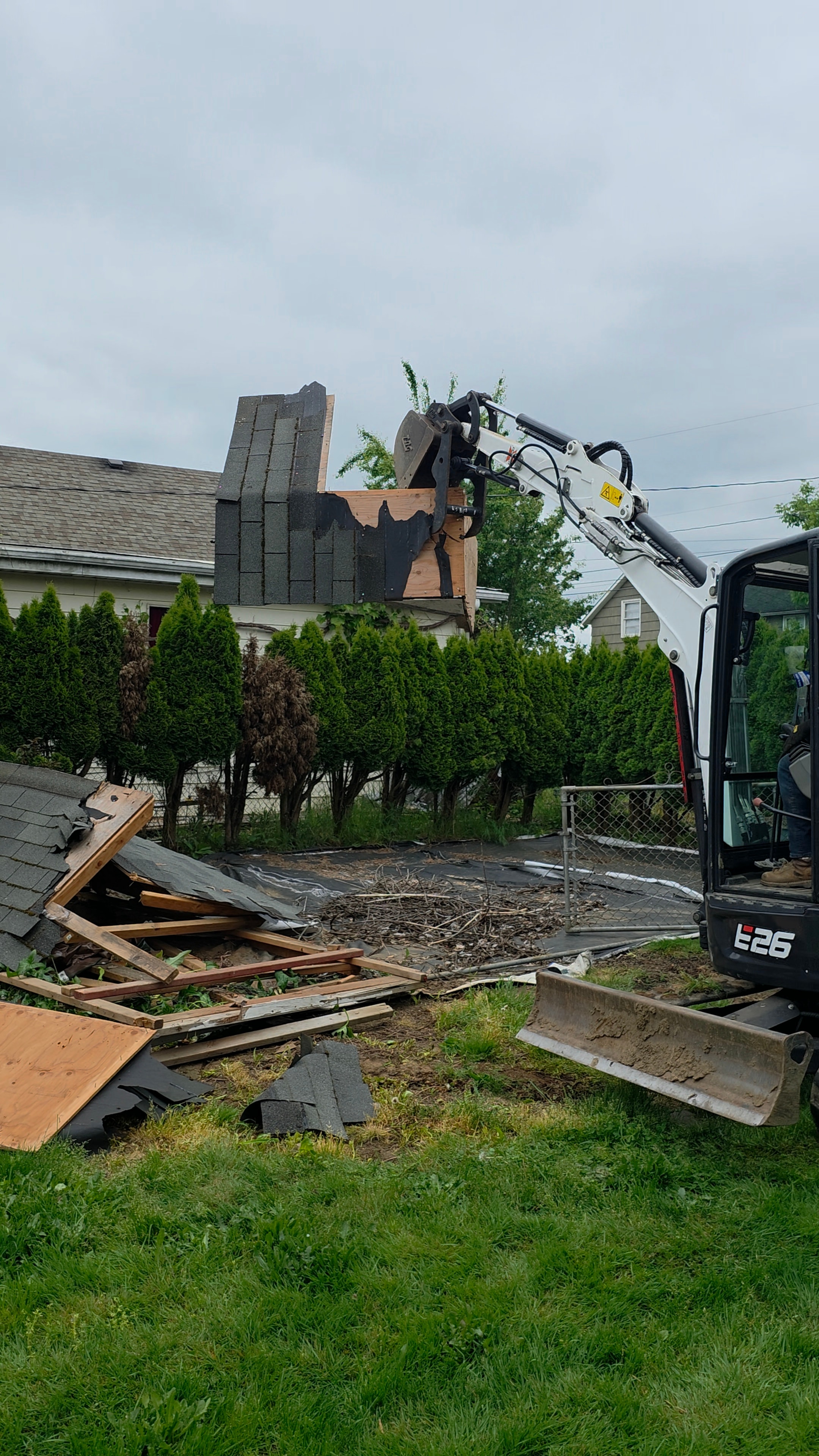Equipment removing roof shingles and framing material