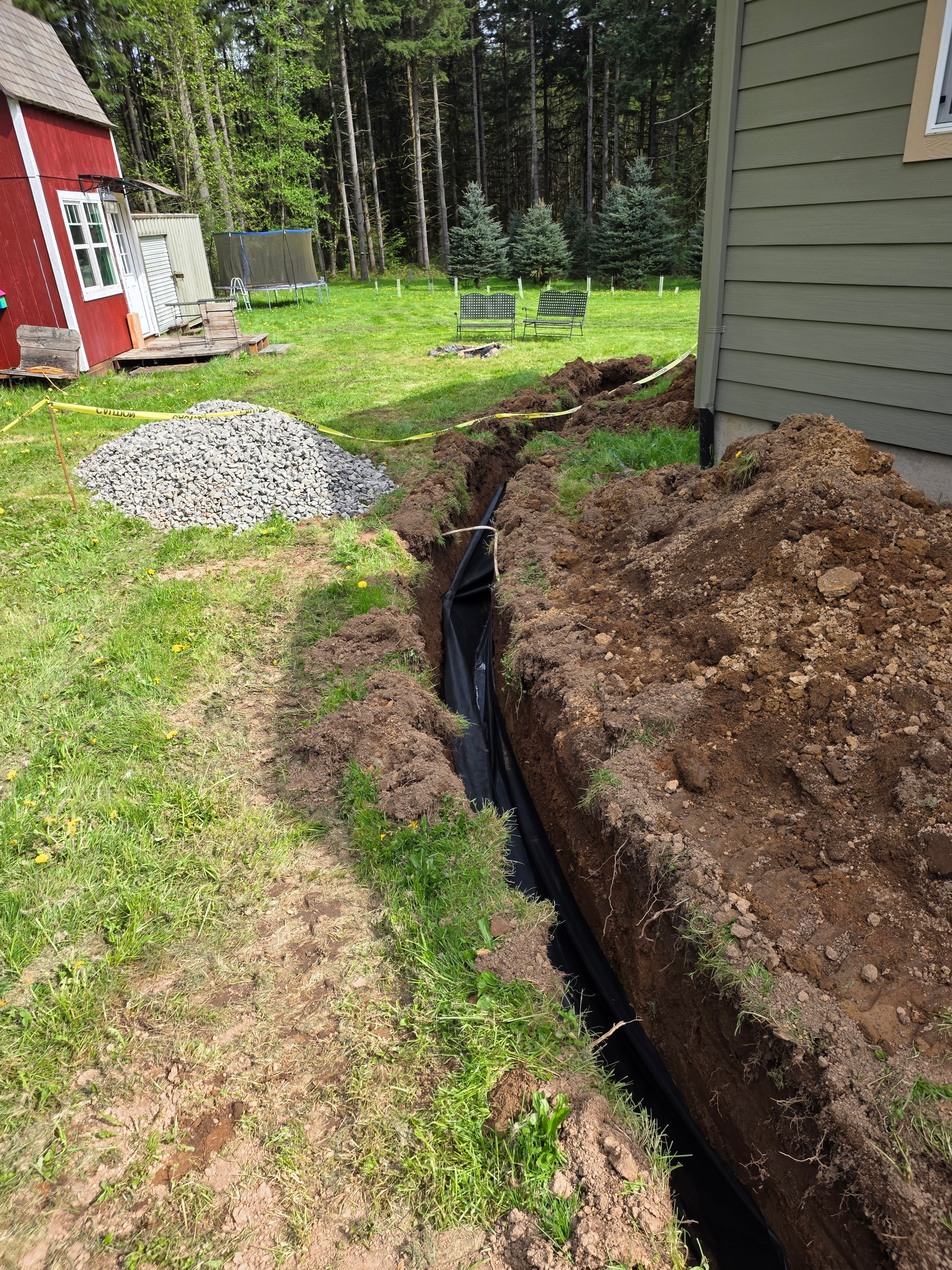 Drain line routed toward backyard slope outlet